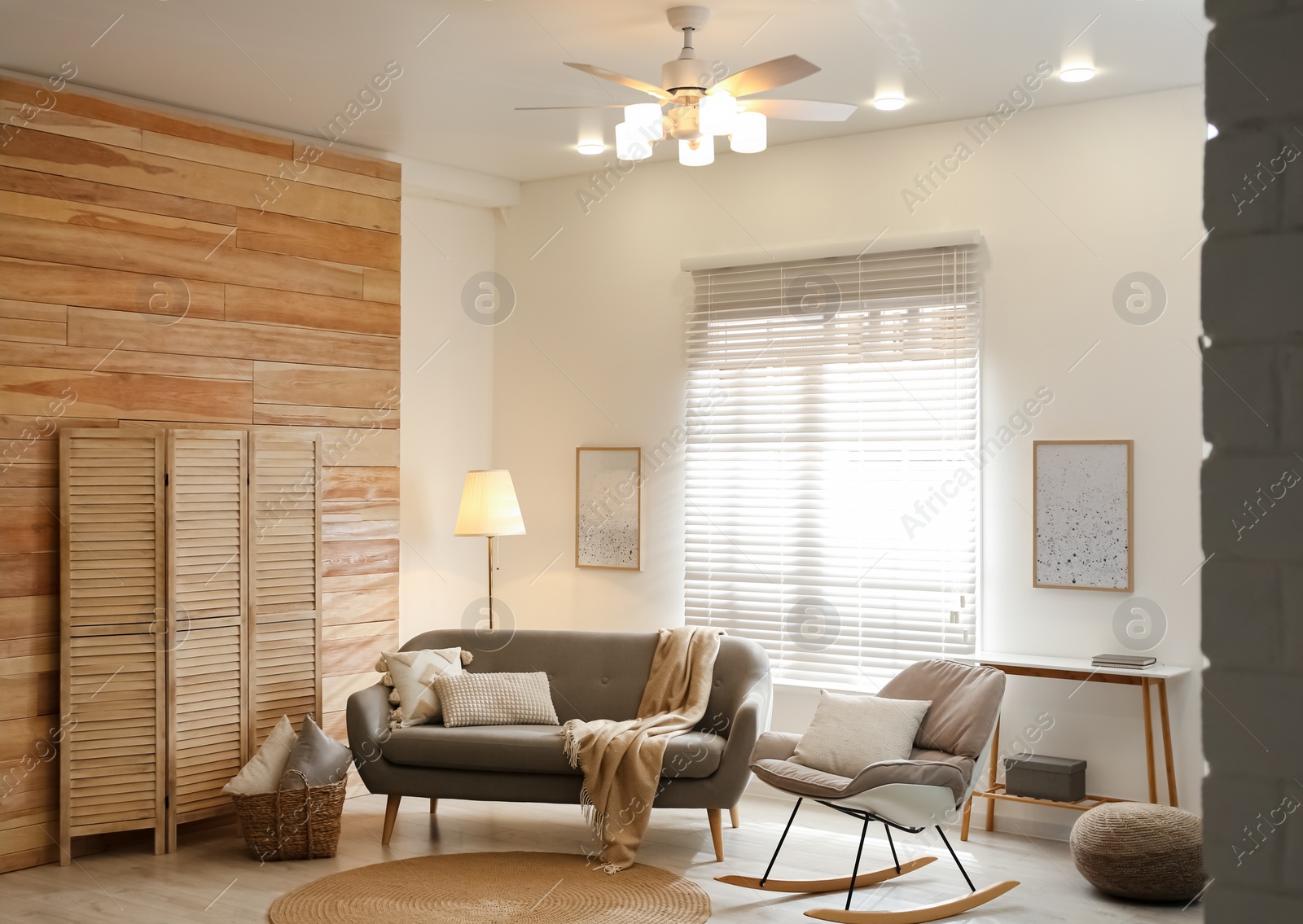 Photo of Stylish living room interior with modern ceiling fan and comfortable sofa