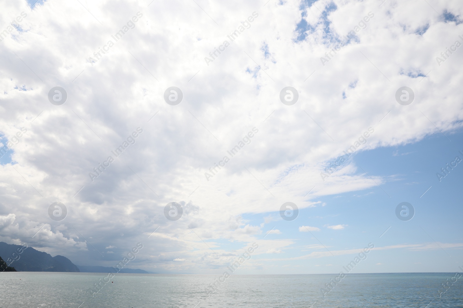 Photo of Picturesque view of sea under beautiful sky with fluffy clouds