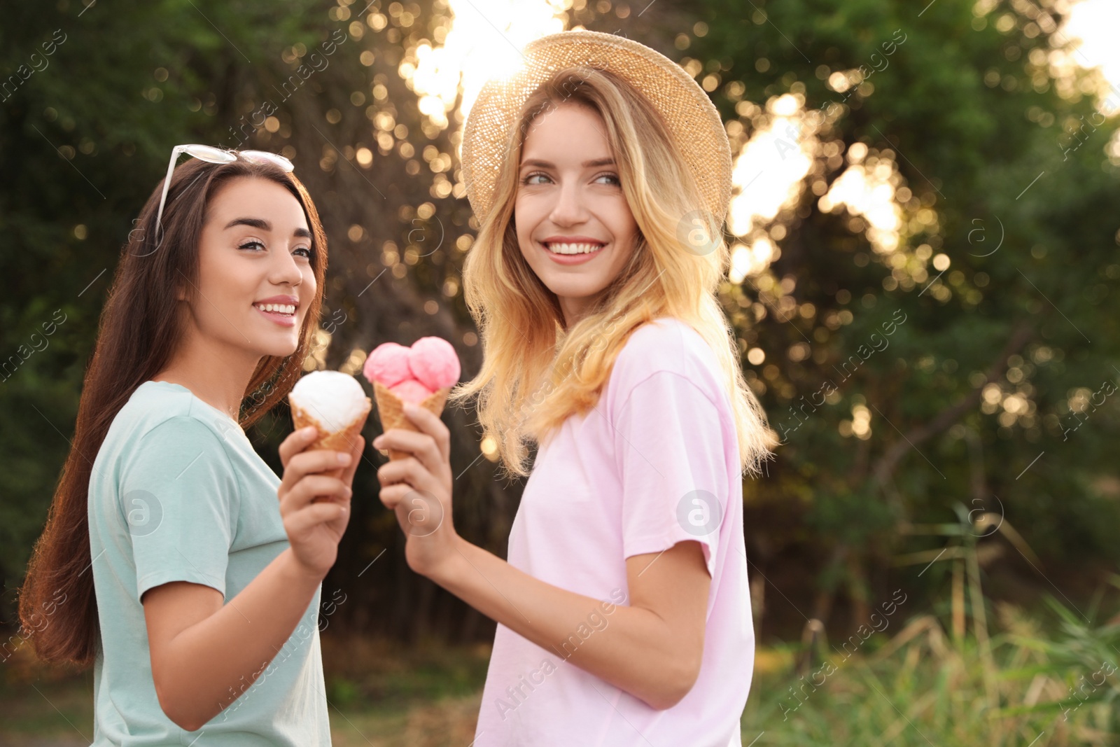 Photo of Young women with ice cream spending time together outdoors