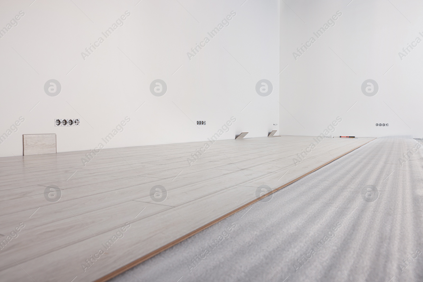 Photo of Light spacious room with unfinished laminate flooring