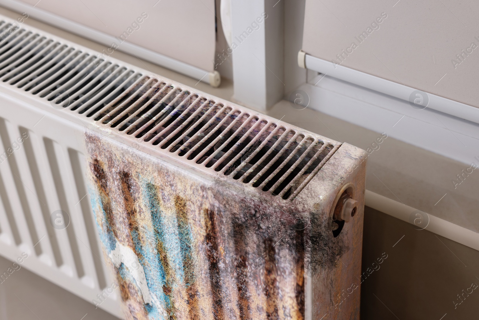 Image of Modern panel radiator affected by rust indoors