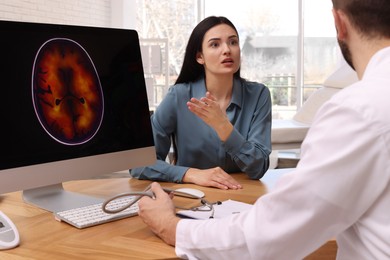 Photo of Young woman having appointment with neurologist in clinic