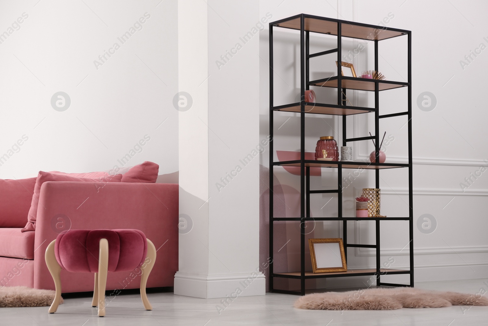Photo of Stylish living room interior with comfortable furniture and shelving unit. Modern design