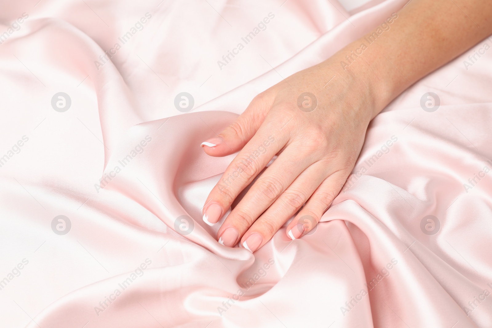 Photo of Woman touching smooth silky fabric, closeup view