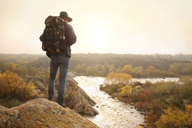 Man enjoying beautiful nature near mountain river, back view