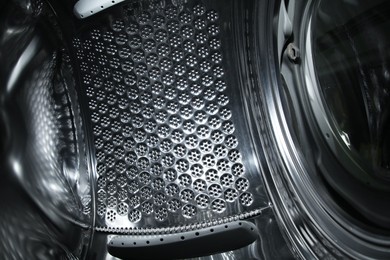 Photo of Empty washing machine drum, closeup view. Laundry day
