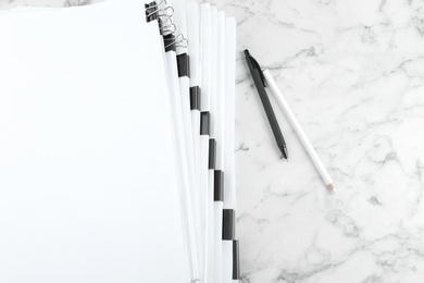 Photo of Stack of documents with binder clips on marble table, top view