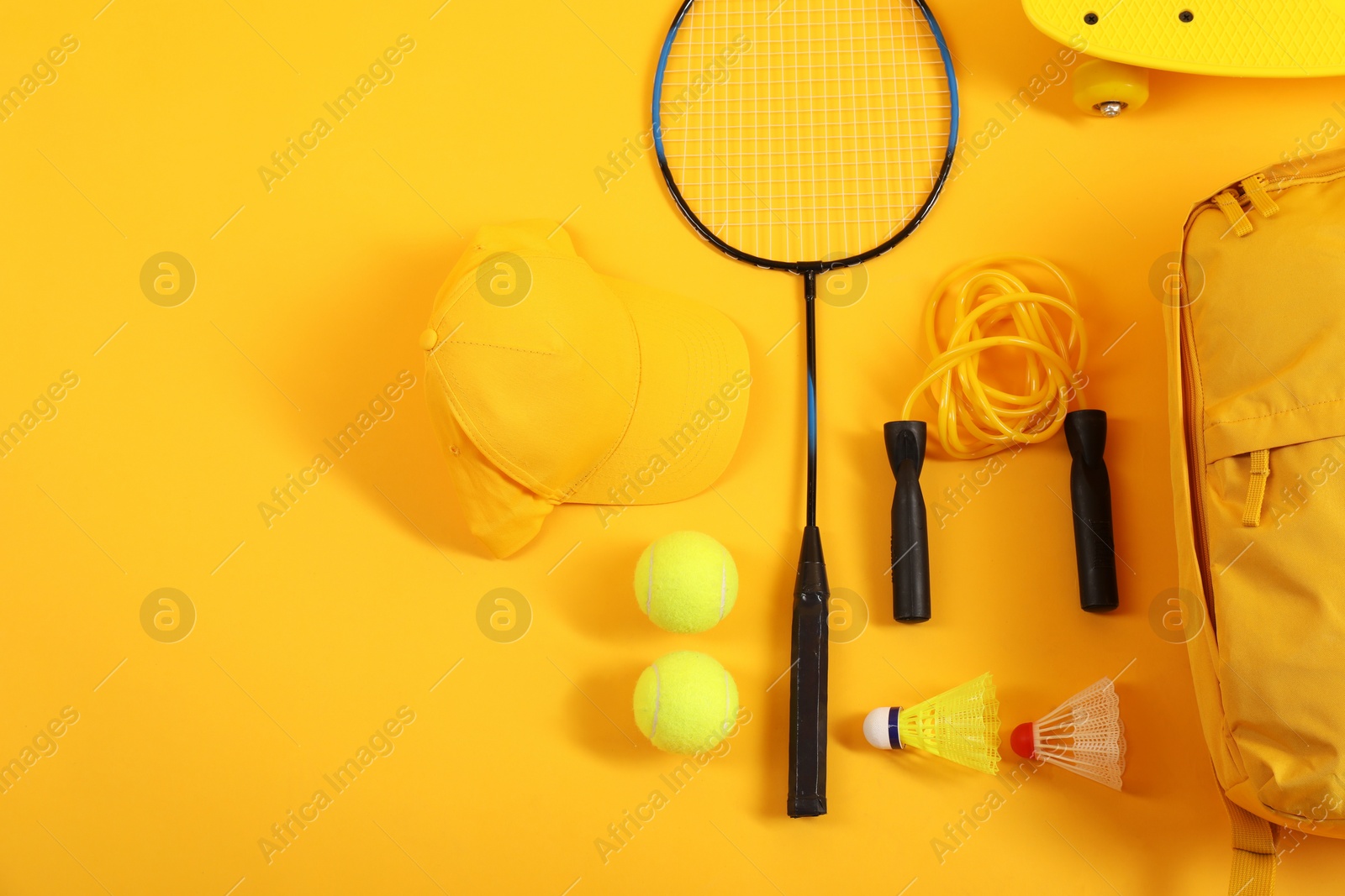 Photo of Different sports equipment on yellow background, flat lay. Space for text