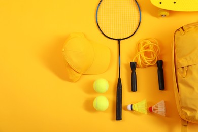 Different sports equipment on yellow background, flat lay. Space for text