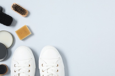 Photo of Flat lay composition with stylish footwear and shoe care accessories on white background, space for text