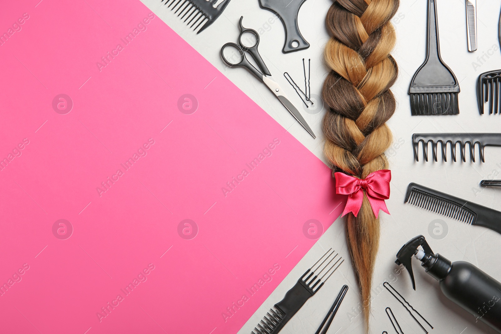 Photo of Flat lay composition with braid, hairdresser's tools and space for text on color background