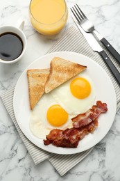 Photo of Delicious breakfast with sunny side up eggs served on white marble table, flat lay