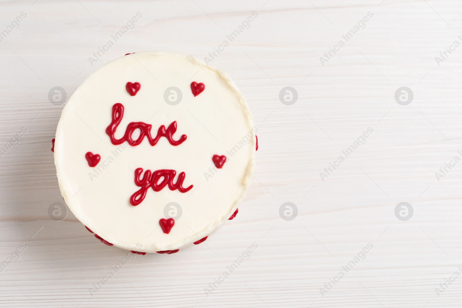 Photo of Bento cake with text Love You and space for text on white wooden table, top view. St. Valentine's day surprise