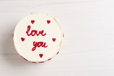 Bento cake with text Love You and space for text on white wooden table, top view. St. Valentine's day surprise