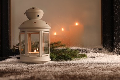 Photo of Lantern with candle and fir branches on snowed window sill outdoors, space for text. Christmas Eve