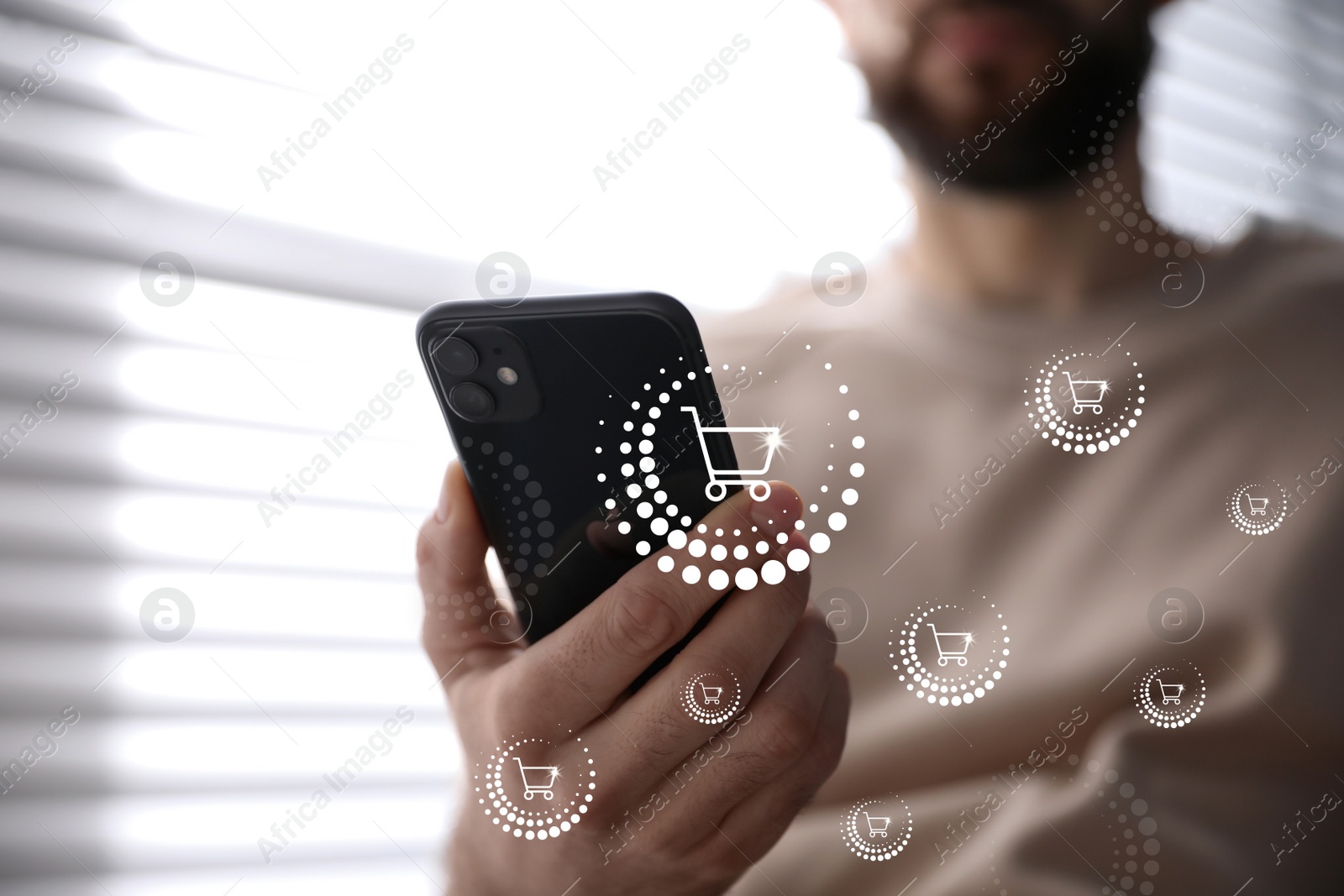 Image of Delivery concept. Man using modern mobile phone for online shopping indoors, closeup. Market cart illustrations