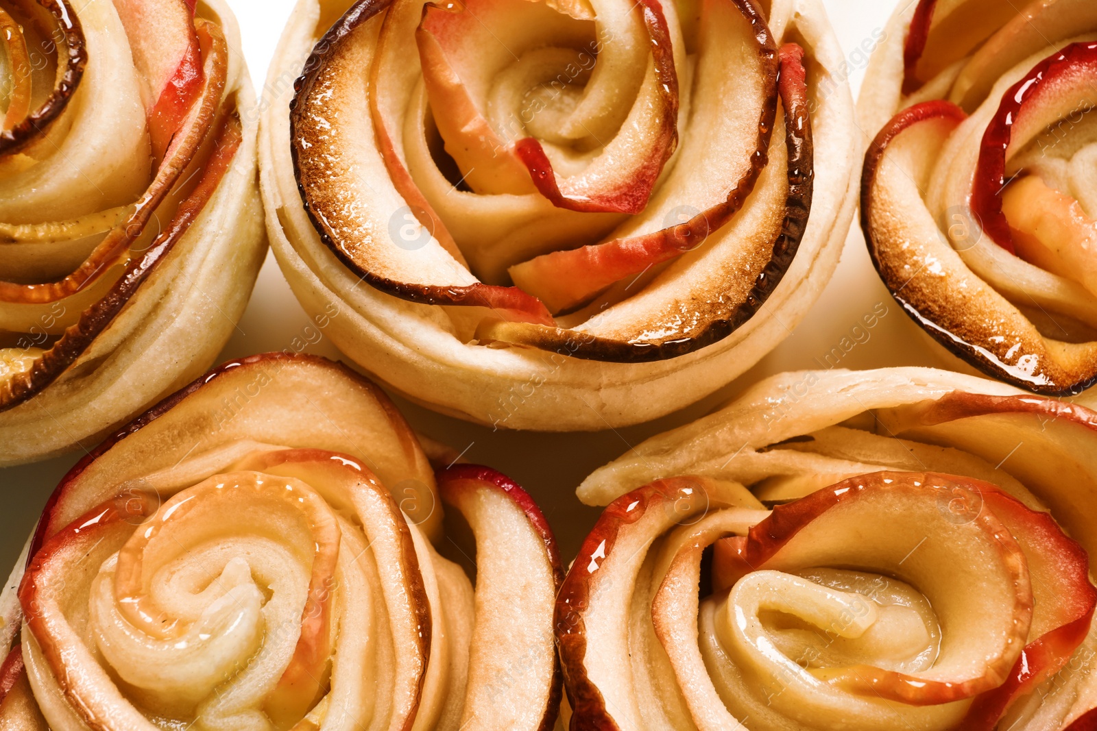 Photo of Freshly baked apple roses, top view. Beautiful dessert