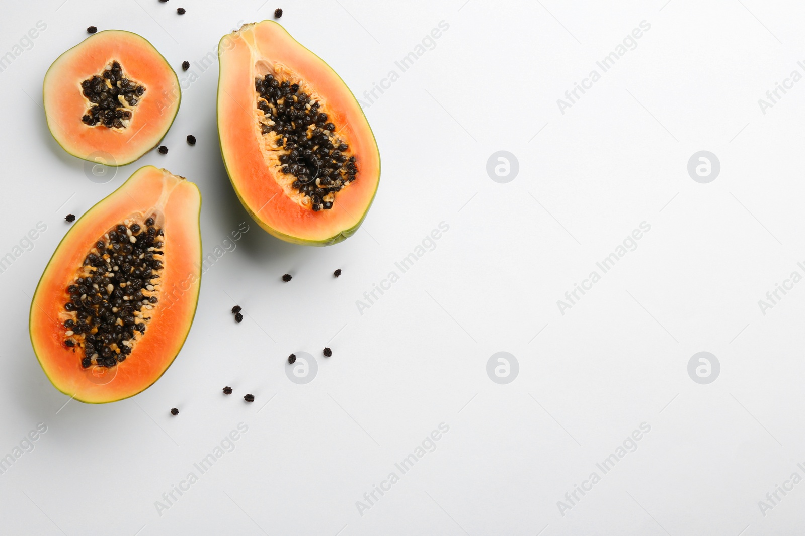 Photo of Fresh ripe papaya fruits on white background, flat lay. Space for text