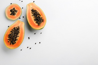 Fresh ripe papaya fruits on white background, flat lay. Space for text