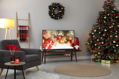 Stylish living room interior with modern TV and Christmas tree