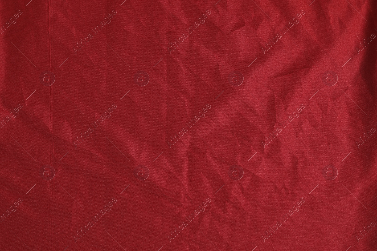 Photo of Crumpled dark red fabric as background, top view