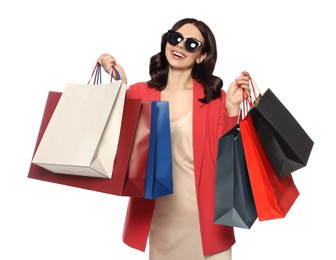 Beautiful young woman with paper shopping bags on white background