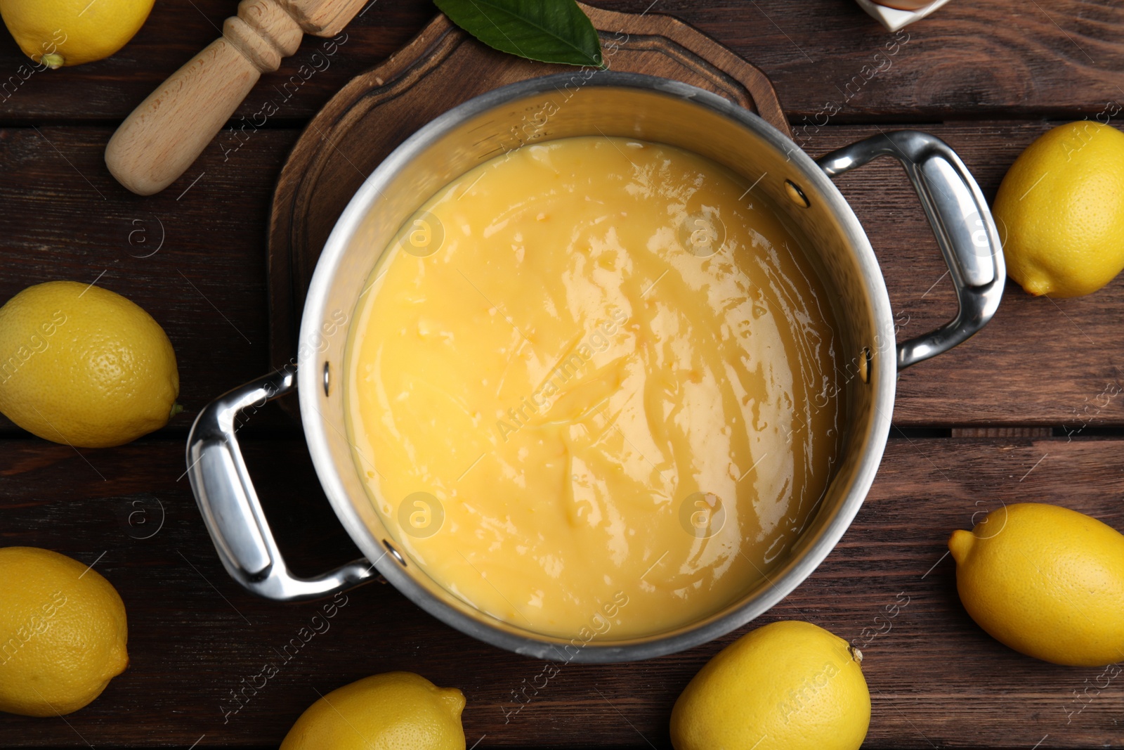 Photo of Delicious lemon curd and fresh fruits on wooden table, flat lay