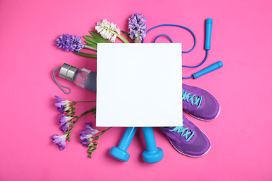 Photo of Flat lay composition with spring flowers, sports items and blank card on pink background. Space for text