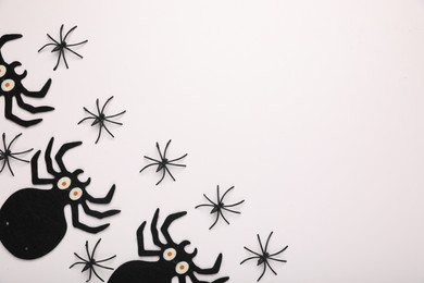 Many different spiders on white background, flat lay and space for text. Halloween celebration