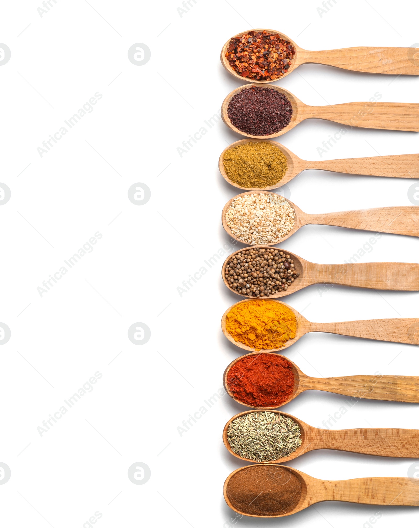 Photo of Composition with different aromatic spices in wooden spoons on white background