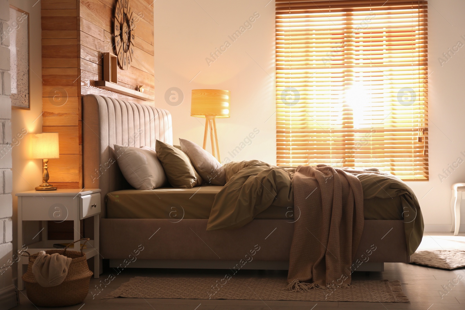 Photo of Comfortable bed with new pistachio linens in modern room interior