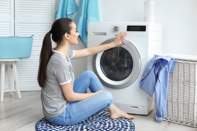 Young woman doing laundry at home