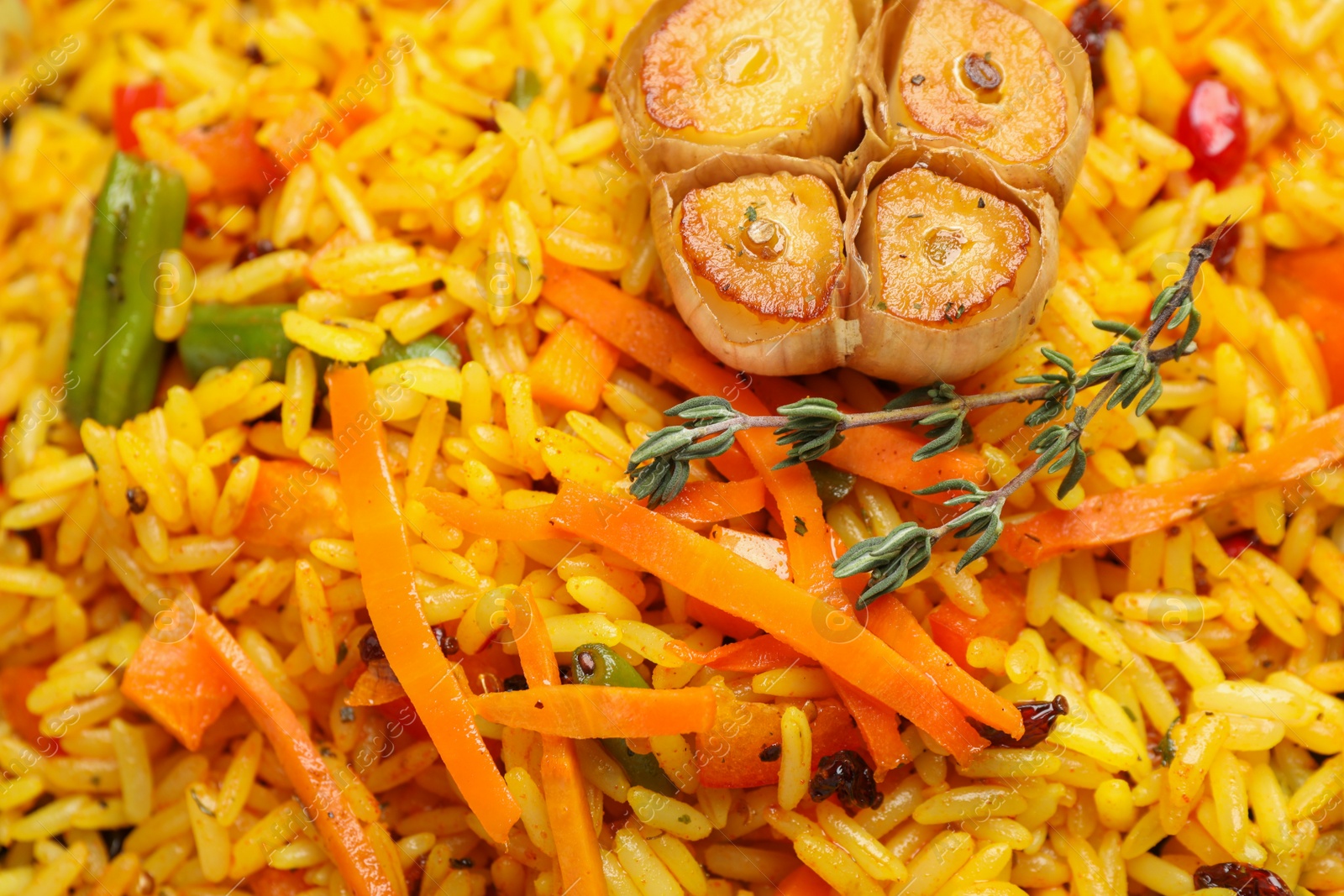 Photo of Tasty rice pilaf with vegetables as background, closeup