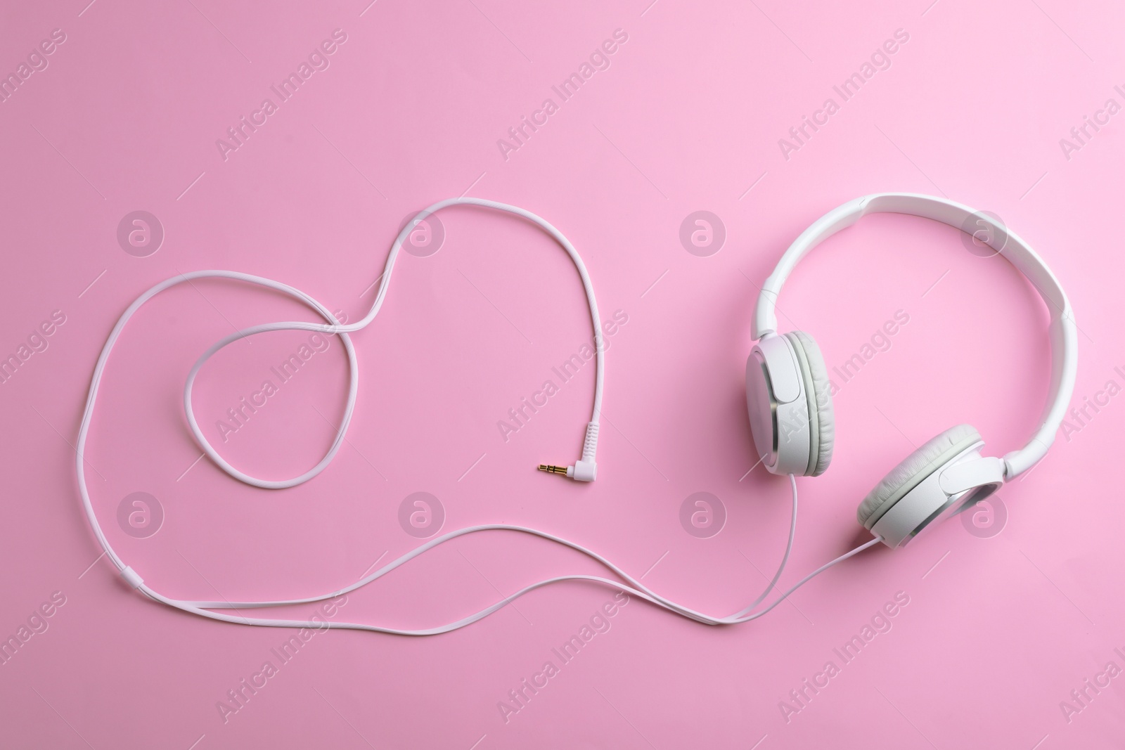 Photo of Stylish headphones on color background, top view