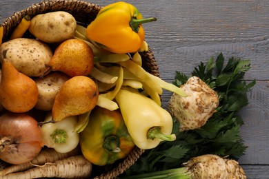 Photo of Different fresh ripe vegetables and fruits on grey wooden table, flat lay