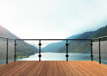 Outdoor wooden terrace revealing picturesque view on lake between mountains