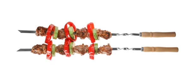 Metal skewers with delicious meat and vegetables on white background, top view