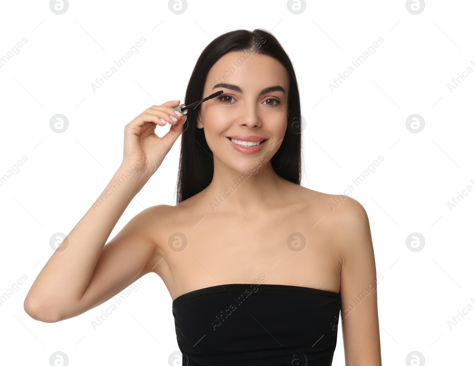 Photo of Beautiful young woman applying mascara on white background