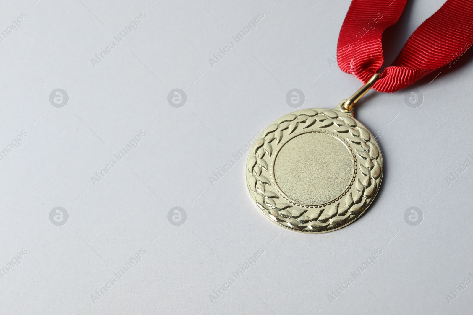 Photo of Gold medal with space for design on light background. Victory concept