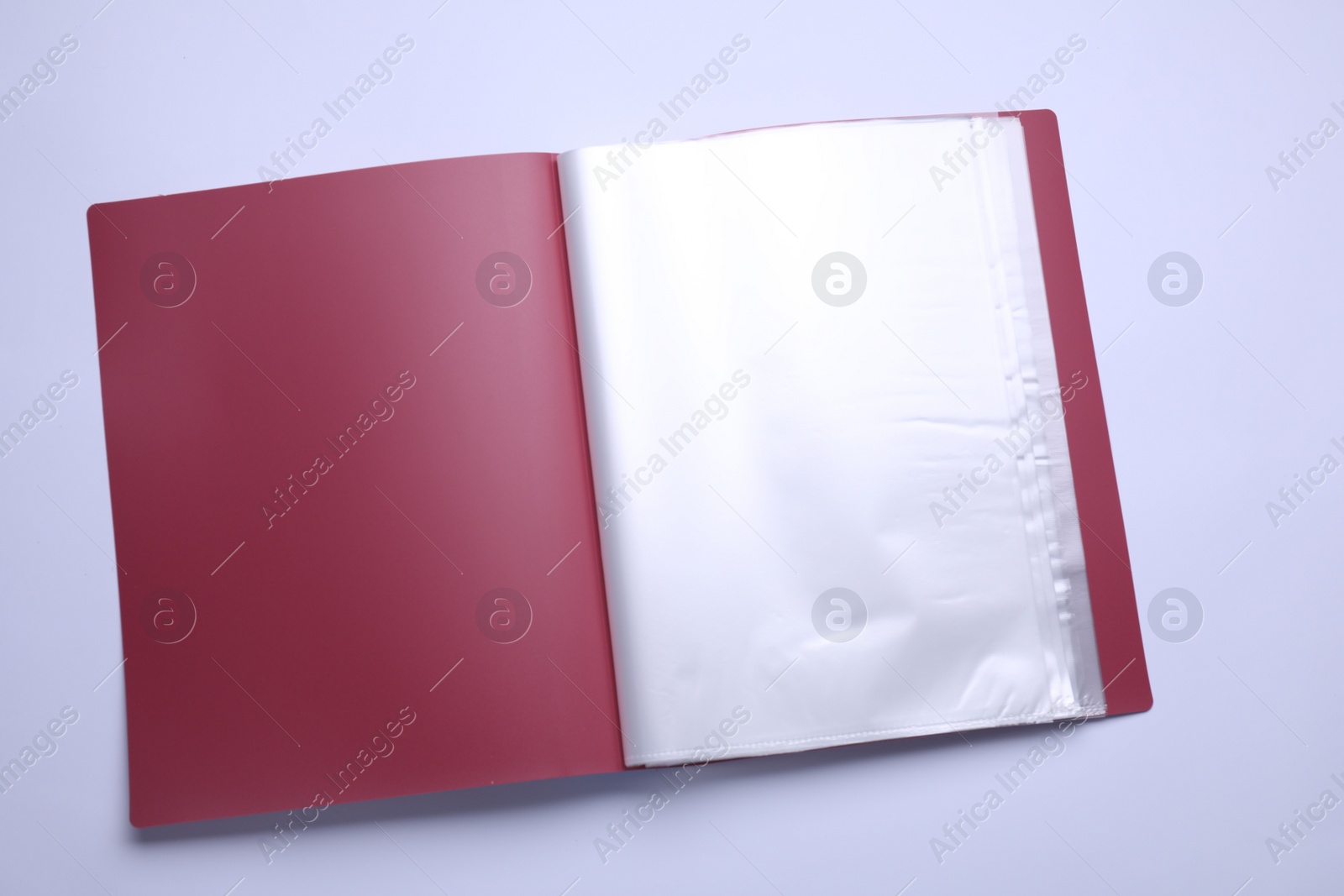 Photo of File folder with punched pockets and paper sheets isolated on white, top view