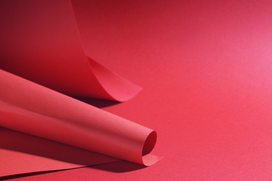 Paper sheets on red background, space for text