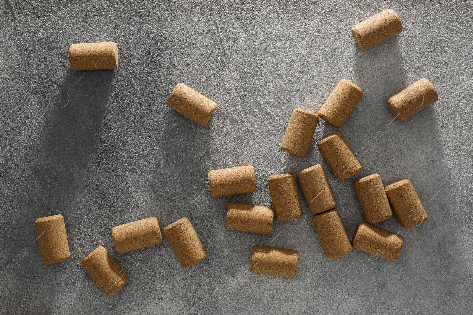 Photo of Wine bottle corks on grey table, flat lay