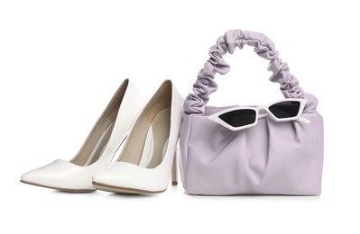 Photo of Stylish woman's bag, sunglasses and shoes isolated on white