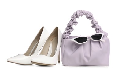 Stylish woman's bag, sunglasses and shoes isolated on white