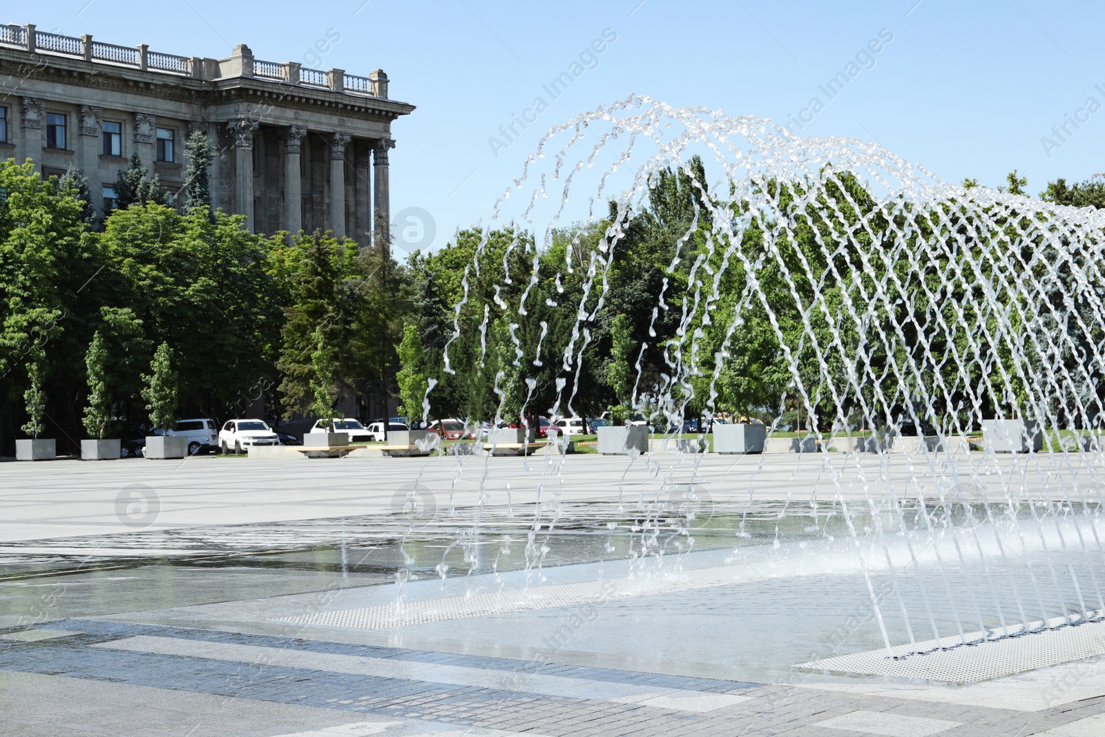 Photo of City square with beautiful fountains on sunny day