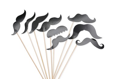 Photo of Fake paper mustaches with party props isolated on white, top view