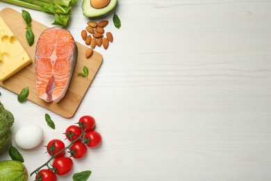 Photo of Flat lay composition with fresh organic products on white wooden table, space for text. Keto diet