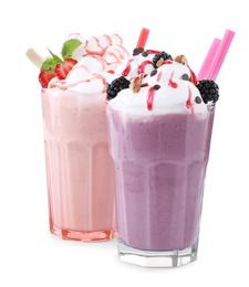 Photo of Tasty milk shakes in glasses on white background