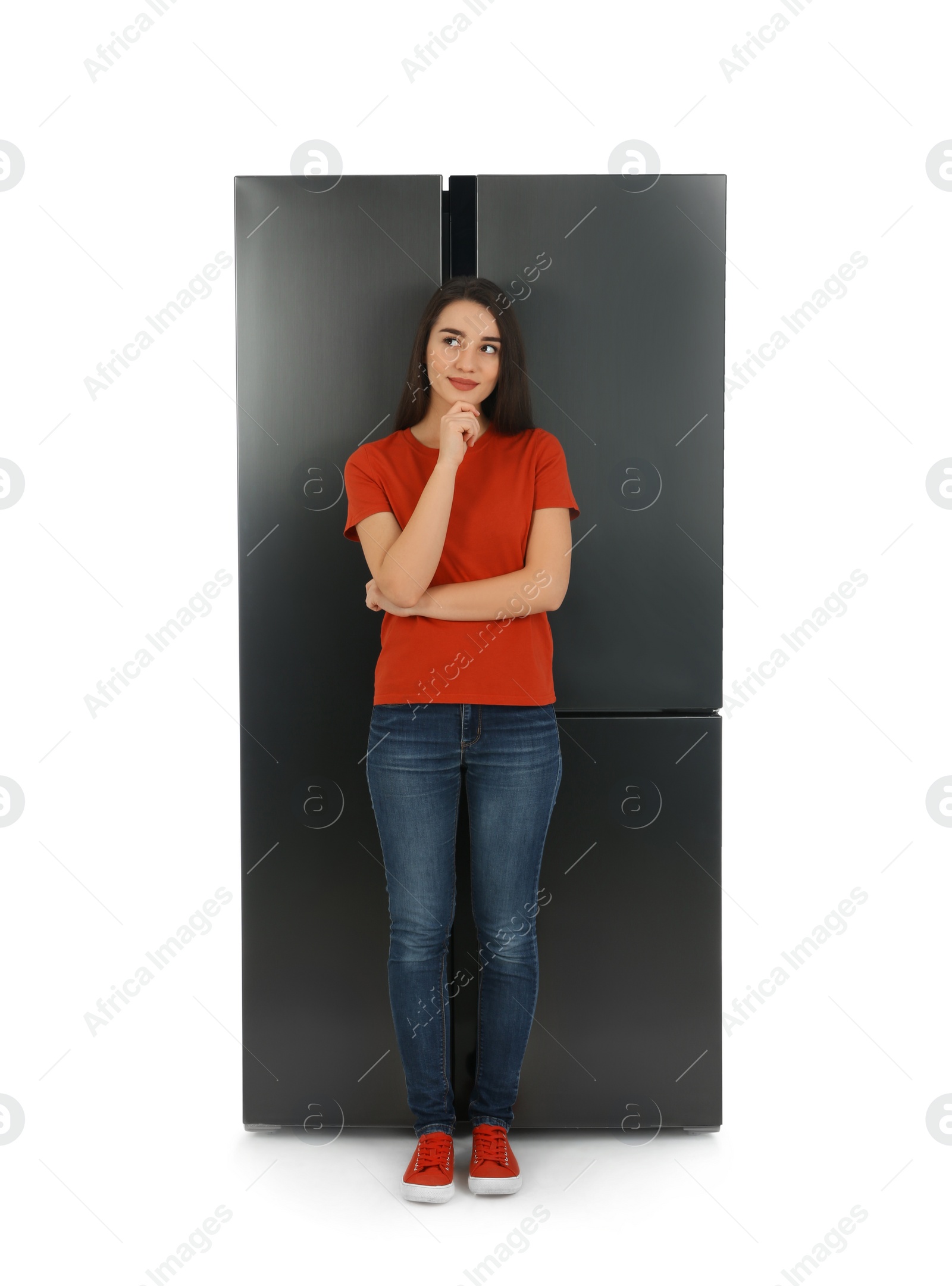 Photo of Young woman near refrigerator on white background