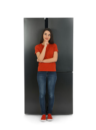 Photo of Young woman near refrigerator on white background